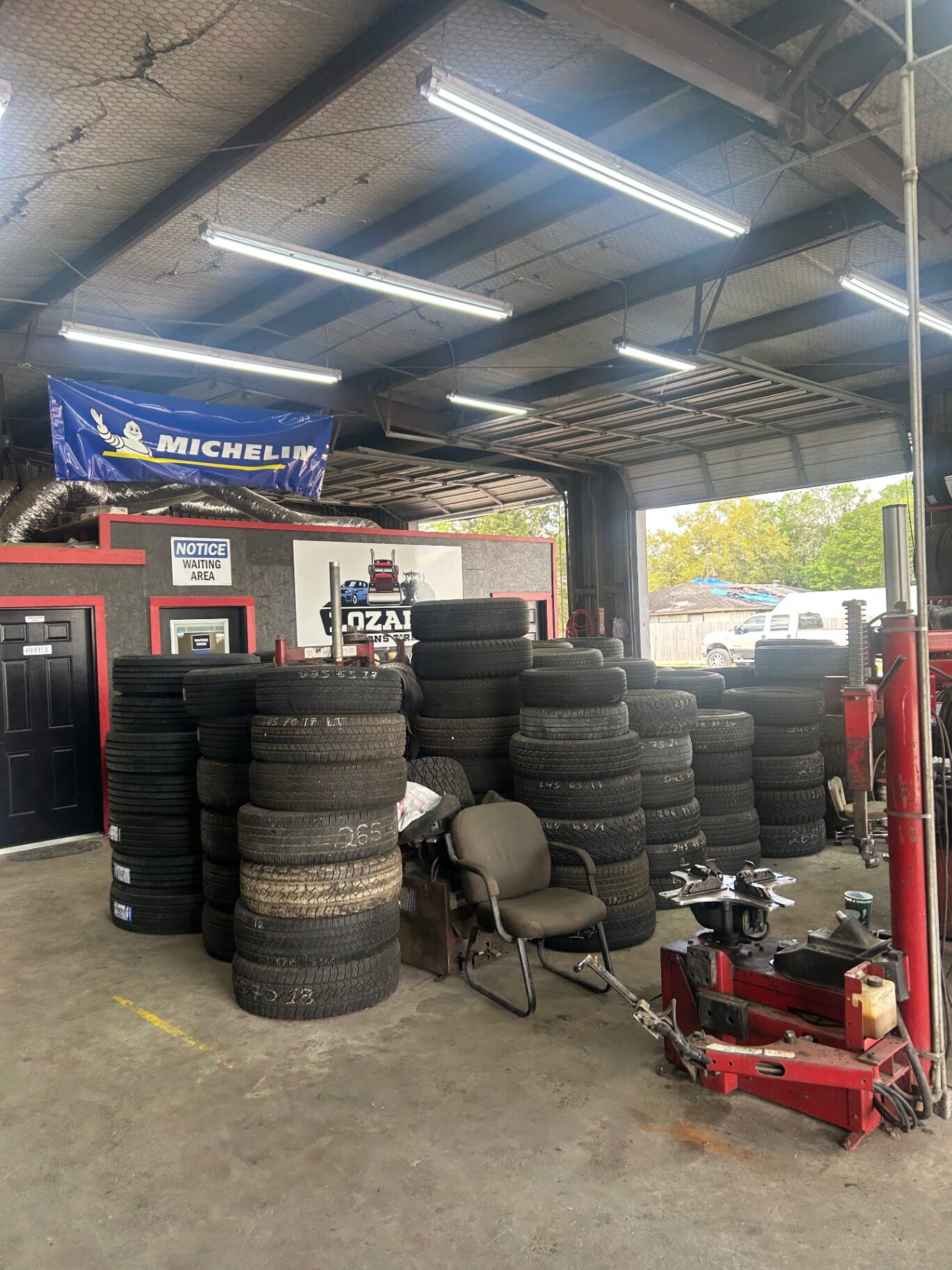 Inside the Lozano & Sons shop with tire inventory and Michelin banner