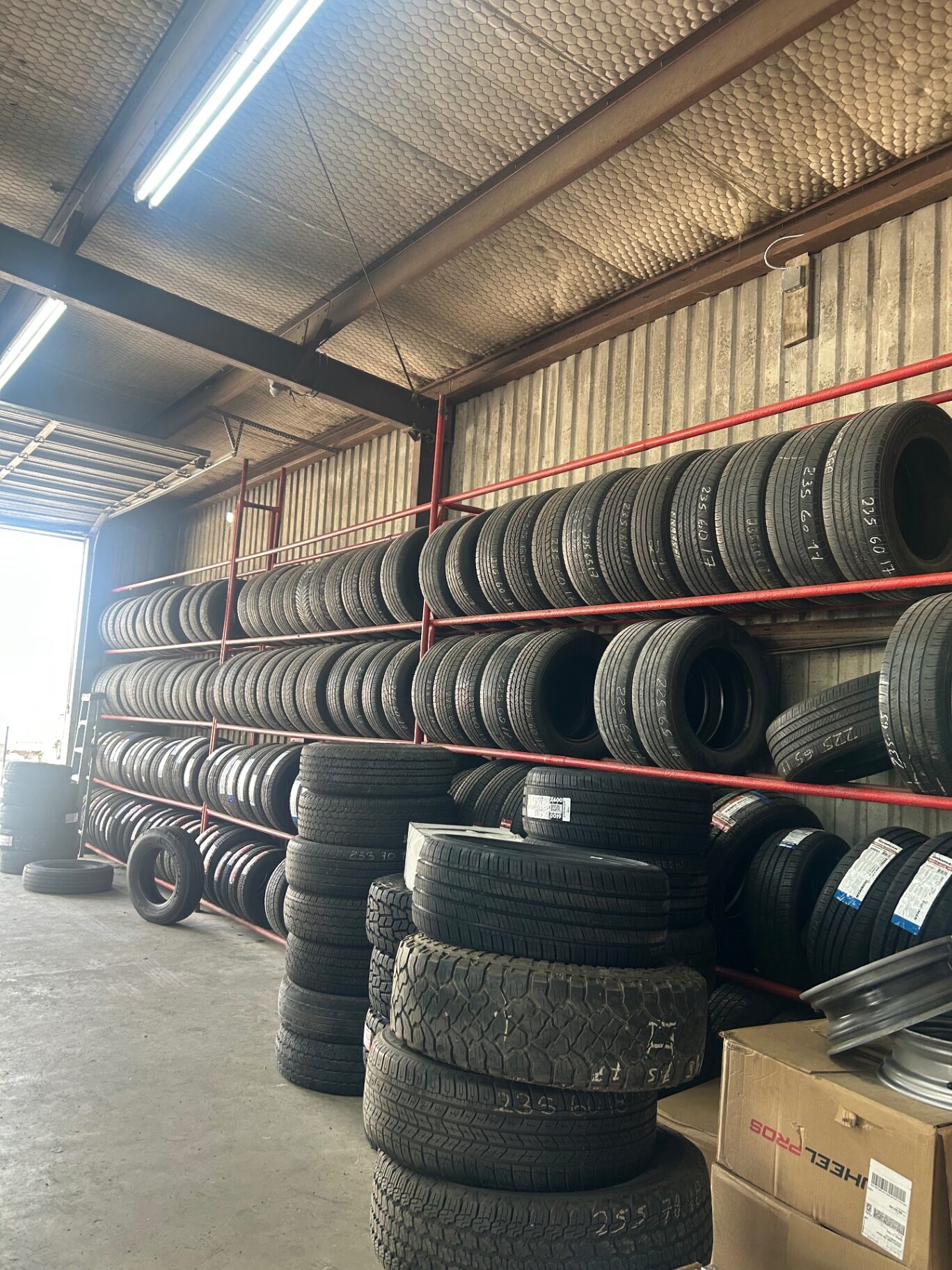 Wall of organized used tire inventory by size